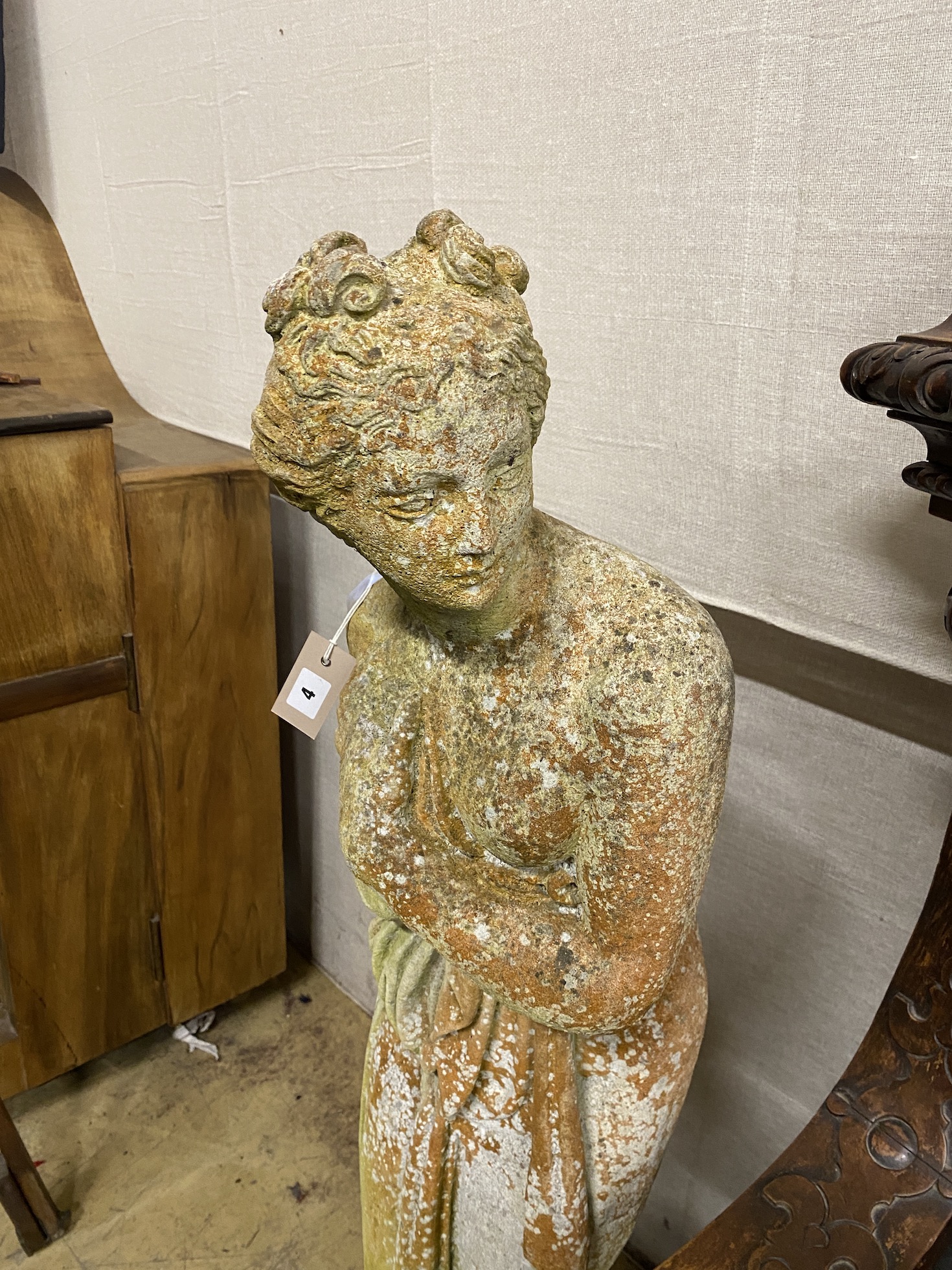 A reconstituted stone garden statue of a female bather, height 117cm